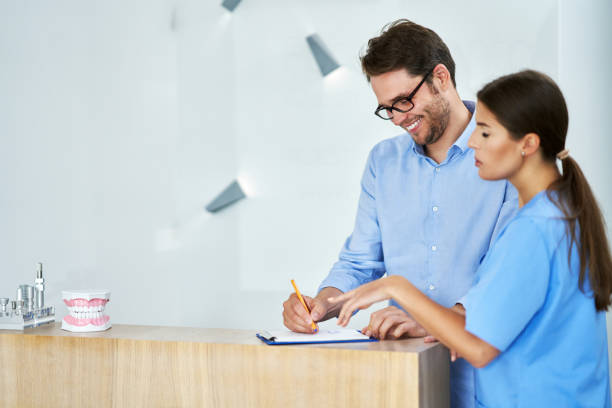 istock Patient signing documents in dental clinic 1278557138