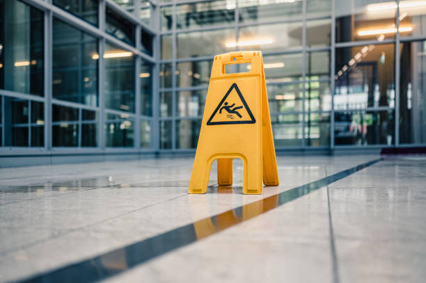 Warning sign slippery Yellow sign on floor that alerts for wet floor. Slip And Fall Accidents stock pictures, royalty-free photos & images