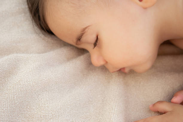 istock Cute baby boy sleeping at the beach 1278558148
