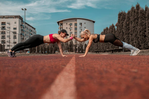 istock Two female athletes limbering up for a race 1278558201