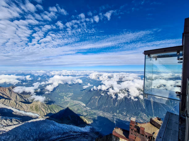 Step into the Void - Aiguille du Midi Skywalk Glass box susspendend over the Chamonix. The Aiguille du Midi. The Aiguille du Midi is a 3,842-metre-tall mountain in the Mont Blanc massif within the French Alps. It is a popular tourist destination and can be directly accessed by cable car from Chamonix that takes visitors close to Mont Blanc.Chamonix needles, Mont Blanc, Haute-Savoie, Alps, France aiguille de midi photos stock pictures, royalty-free photos & images