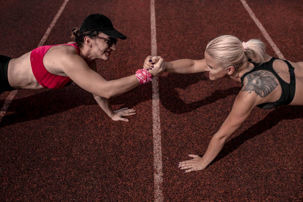istock Two female athletes limbering up for a race 1278558256