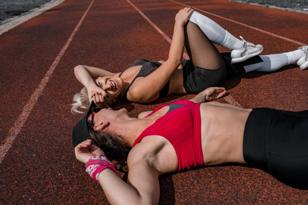 istock Two female sprinters resting after a race 1278558644