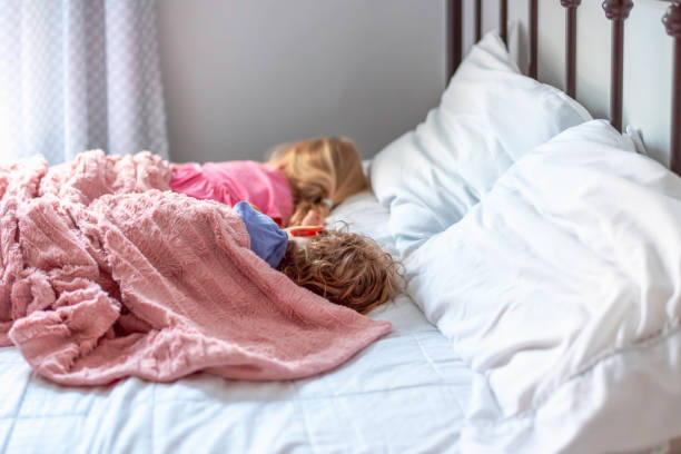 istock High Angle View Of Cute Kids Sleeping On Bed 1278558896