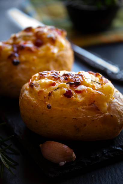 istock Baked potatoes stuffed with cheese, vegetables and rosemary 1278561203