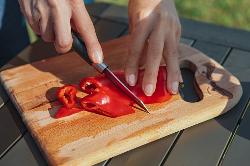 Woman chopping red pepper