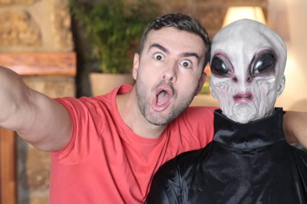 istock Surprised man taking a selfie with an alien 1278561335
