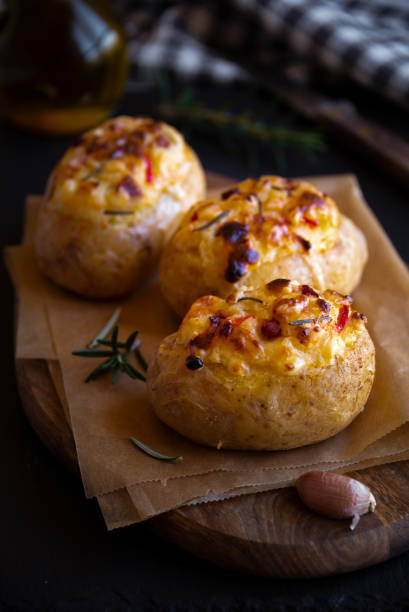 istock Baked potatoes stuffed with cheese, vegetables and rosemary 1278561342