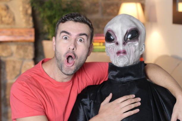 istock Man taking a picture with funny looking alien 1278561350