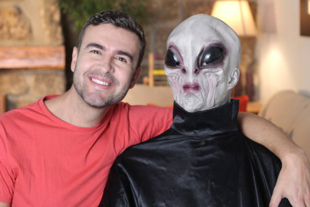 istock Man taking a picture with an alien 1278561382