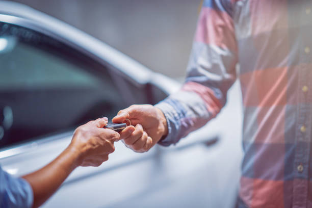 Car dealer giving keys to a customer stock photo