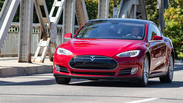 Tesla Model S Driving Across a Bridge stock photo