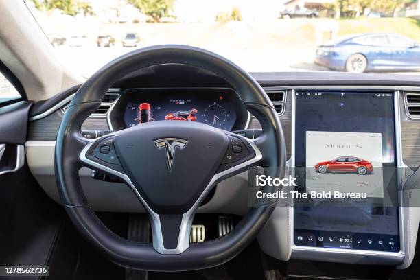 Driver Perspective In A Charging Red Tesla Model S Stock Photo - Download Image Now - Mobile App, Steering Wheel, Battery