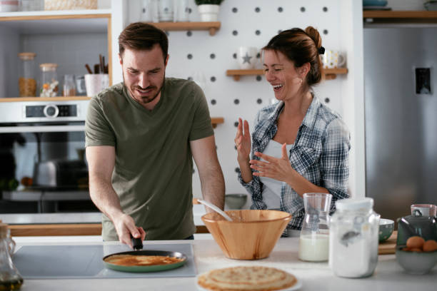 istock Young couple making pancakes at home 1278564500