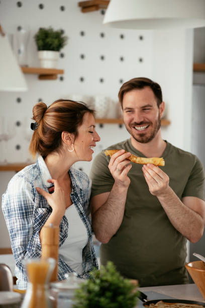 istock Young couple making pancakes at home 1278564624