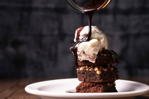 Brownies with Ice cream 3 layers of brownies with ice cream on top and poured with chocolate syrup dessert stock pictures, royalty-free photos & images