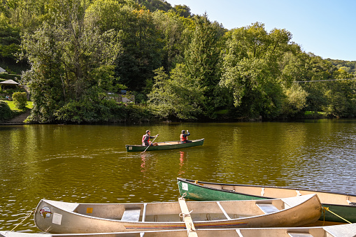 Symonds, Yat, England - September 2020:  Two people in a canoe on the River Wye in Symonds Yat.