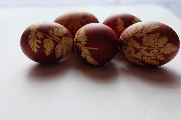istock Painted Easter eggs on a white background. Floral pattern on a red eggshell. Festive food. 1278566020