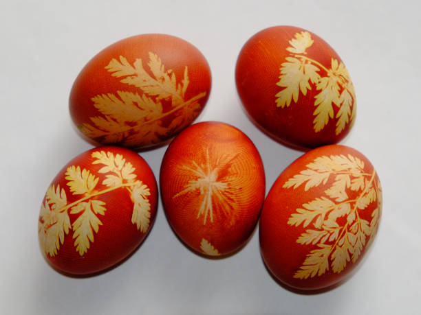 istock Painted Easter eggs on a white background. Floral pattern on a red eggshell. Festive food. 1278566072