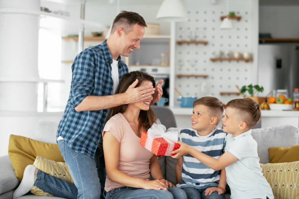 istock Two young sons are giving their mother a gift. 1278566739