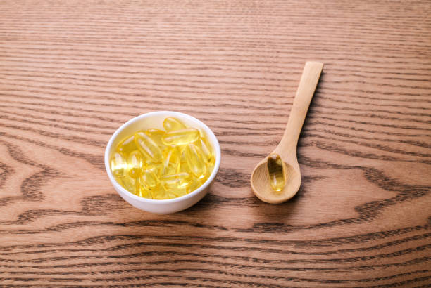 istock Fish oil pills on the wooden table. 1278567400