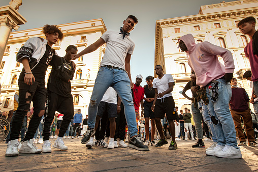 Florence, Italy - 2020, September 26:\nUnidentified B-boy break dances perform in the street for the crowd. Hip Hop battle at a informal street dance meet.