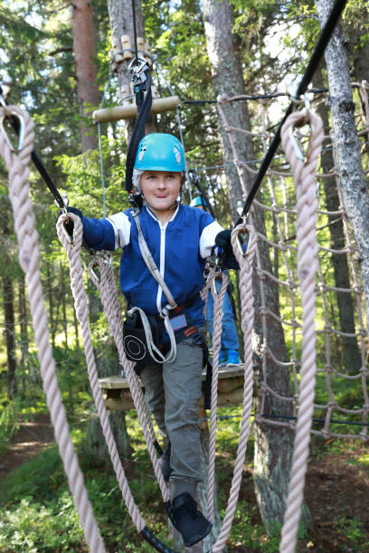 istock Child overcoming hanging ropes obstacle 1278572261