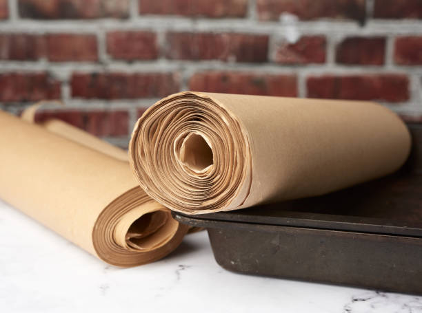 istock metal pan and rolls of brown parchment paper on a white table 1278574385