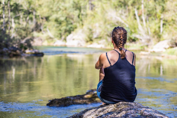 Middle aged woman looking a river