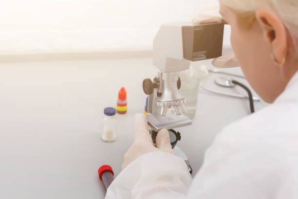 istock A beautiful female medical or scientific researcher using her microscope in a laboratory. 1278579641