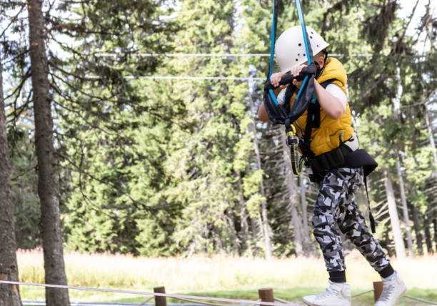 istock Small boy walking on a rope during canopy tour in nature. 1278579914