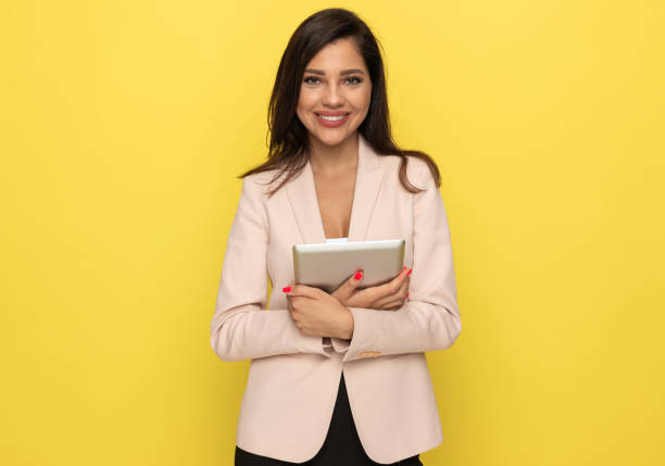istock happy young businesswoman holding tab 1278579981