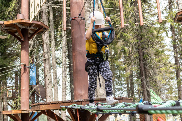 istock Small kid walking on a rope during canopy tour in nature. 1278580000
