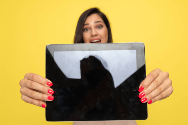 istock surprised young girl holding and showing empty screen 1278580155
