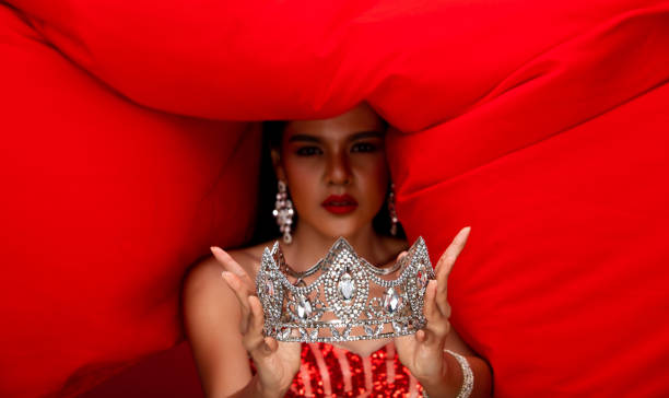 istock she hold winner diamond crown with Red cloth fluttering throw back in Air 1278580620