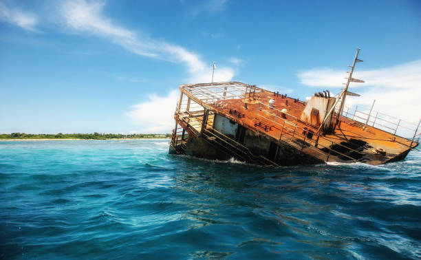 Shipwreck off the Fijian Coast Remnants of a sunken boat at the Fijian coast fishing boat sinking stock pictures, royalty-free photos & images