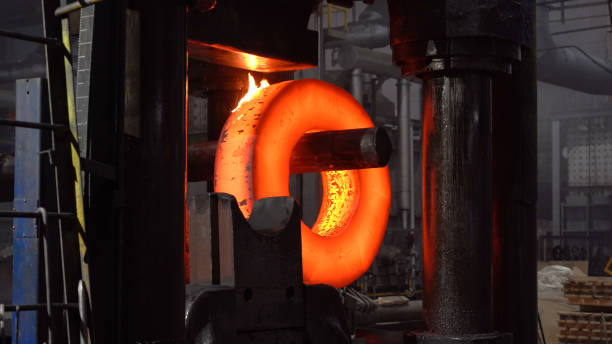Hot iron under a huge press. Metal forging, stamping under hammer forge at workshop of forge foctory. Blacksmithing, metallurgical, steelmaking, hot rolling mill