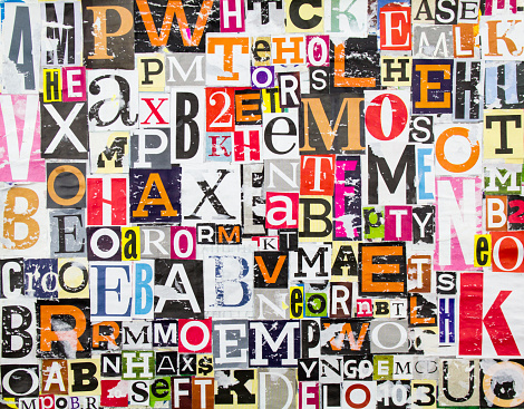Colorful abstract collage from clippings with letters and numbers texture background. Torn and peeling pieces of magazine paper with shabby surface.