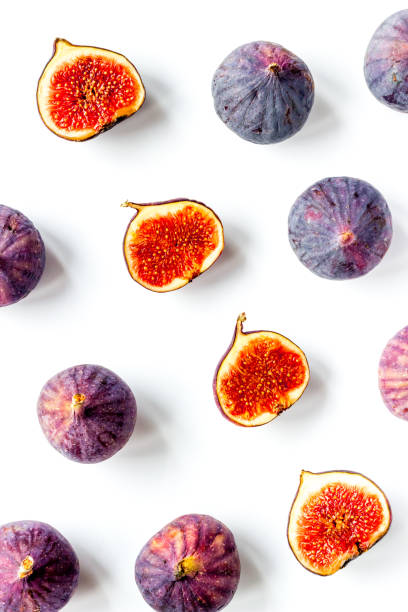 istock Pattern of whole and sliced figs. Overhead view 1278583797