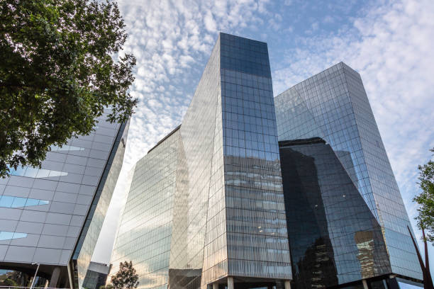 Corporate office, a green building in Sandton with a cirrus cloudscape and reflection in the late afternoon.