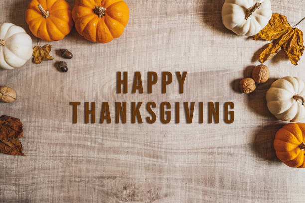 istock Happy Thanksgiving Day with pumpkin and nut on wooden table 1278585452