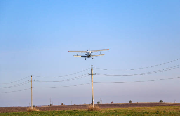 istock small biplane, an agricultural maize plane, with a special diffuser for field fertilizers and pesticides, picks up speed and takes off over the autumn field. 1278585503