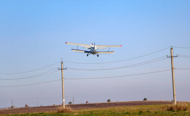 istock small biplane, an agricultural maize plane, with a special diffuser for field fertilizers and pesticides, picks up speed and takes off over the autumn field. 1278585506