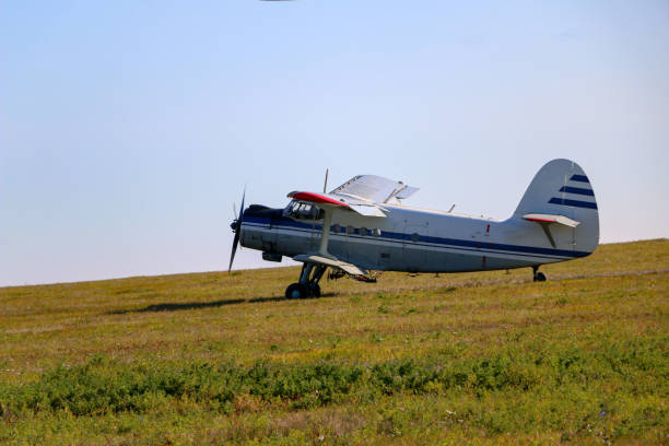 istock small biplane, an agricultural maize plane, with a special diffuser for field fertilizers and pesticides, picks up speed and takes off over the autumn field. 1278585509