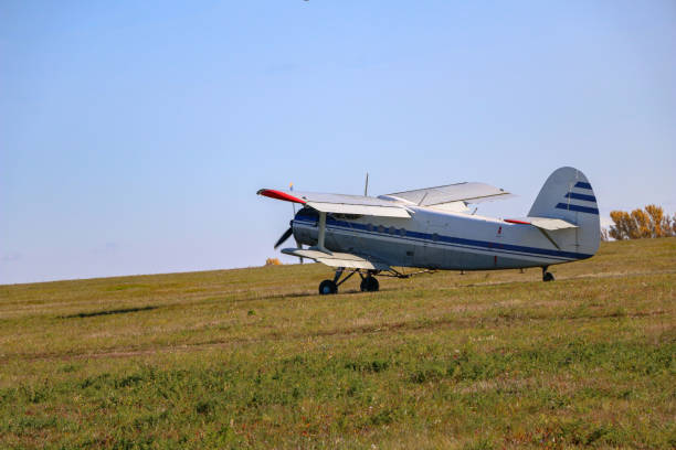 istock small biplane, an agricultural maize plane, with a special diffuser for field fertilizers and pesticides, picks up speed and takes off over the autumn field. 1278585516