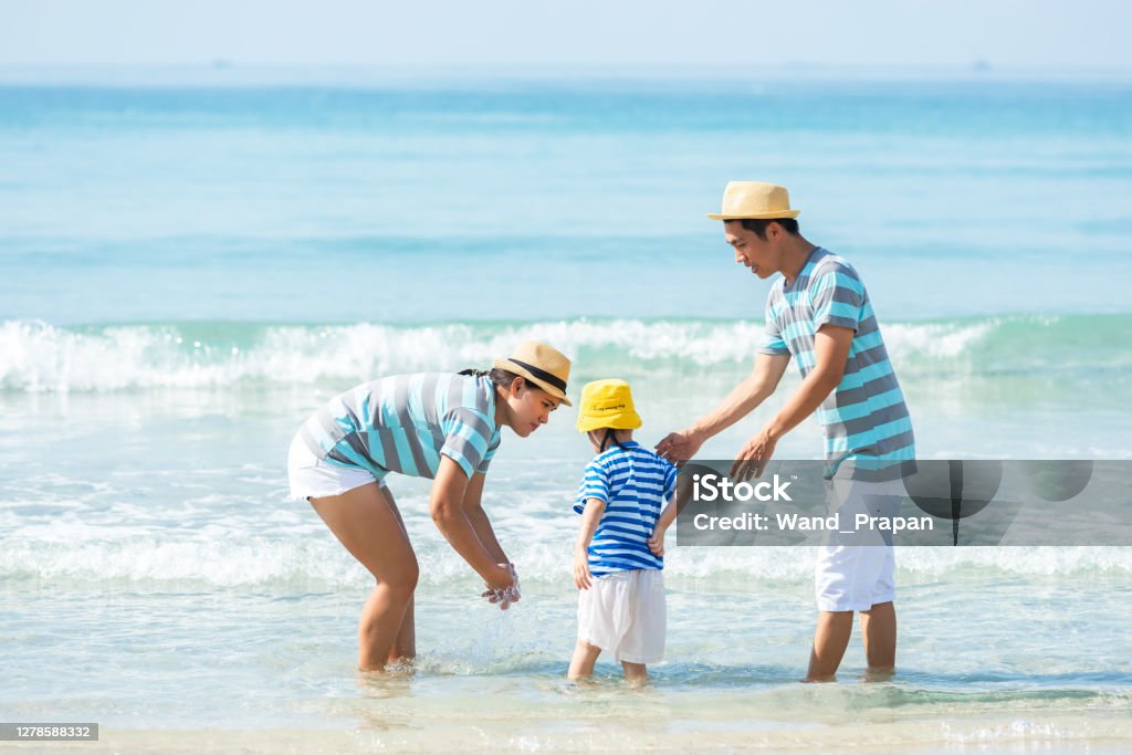 Happy family summer sea  beach vacation. Asia young people lifestyle travel enjoy fun and relax in holiday. Travel and Family Concept Adult Stock Photo