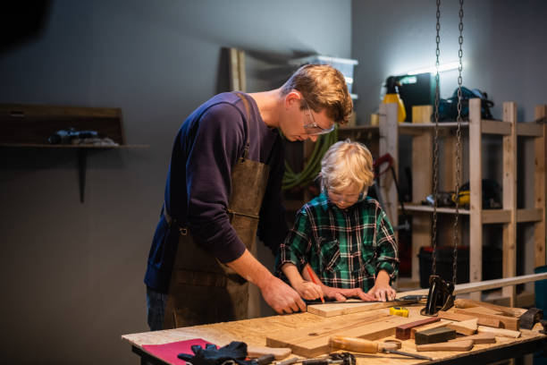 istock an experienced carpenter and his young apprentice make wood crafts in their workshop 1278588348