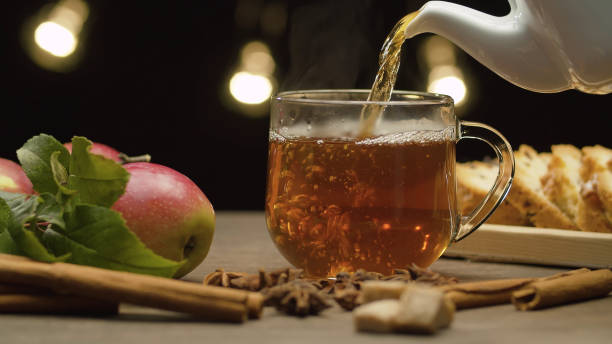 Tea pouring into glass mug