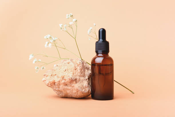 istock A glass bottle stands with aromatic oil on a stone. 1278590033