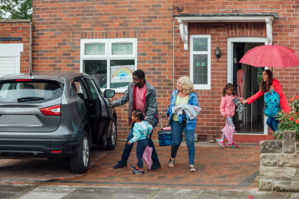 Going on a Road Trip Three generation family leaving their house heading to the car to go on a road trip. Taken during the Covid 19 pandemic. northern europe family car stock pictures, royalty-free photos & images